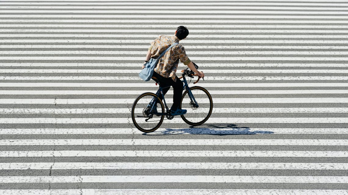 Urban Cyclist Crossing the Street