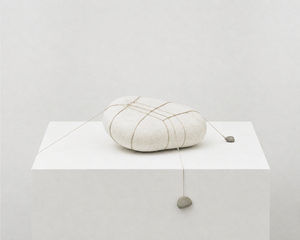 Tensioned symmetry with stone and string